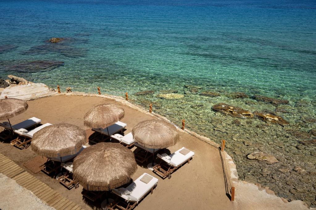 an aerial view of a beach with chairs and umbrellas at Callisto Azzure in Zakynthos