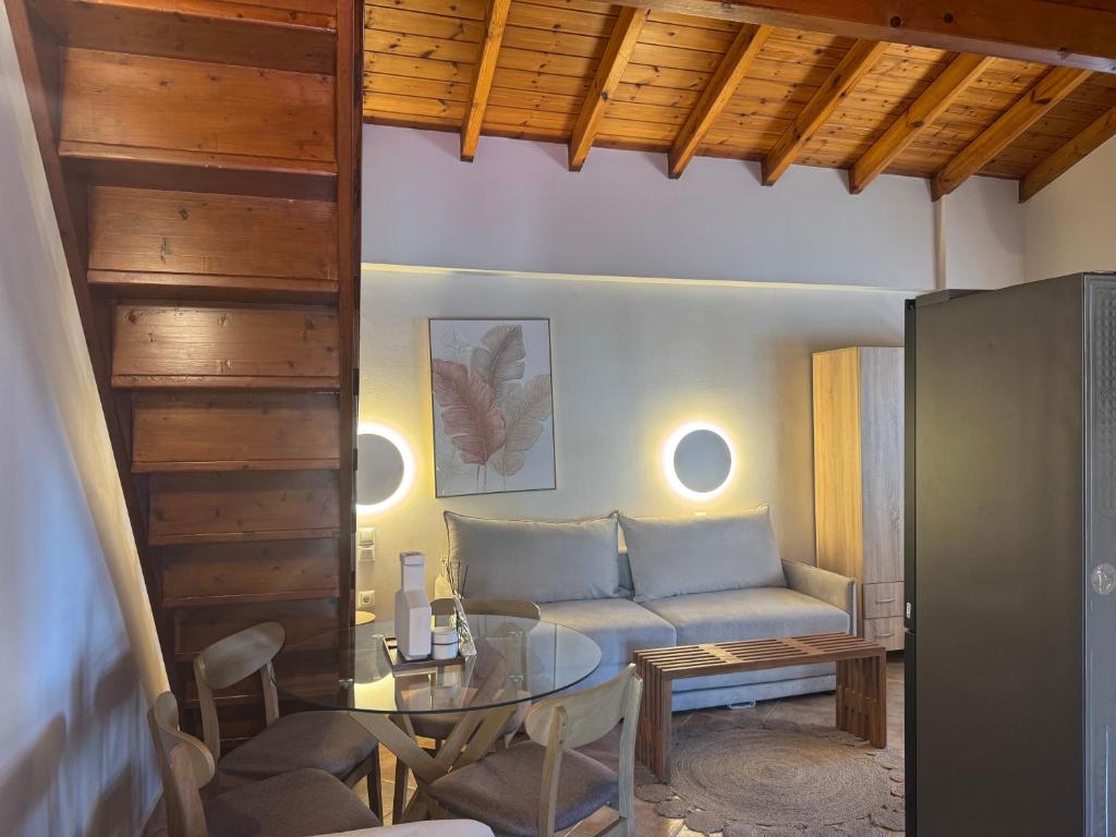a living room with a couch and a table at Mersea standard apartment Kourouta in Kourouta