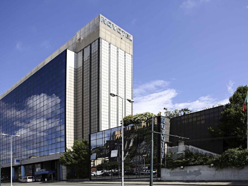 a tall building with a lot of windows at Novotel Genova City in Genoa
