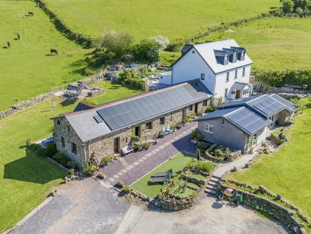 an aerial view of a house with solar panels on it at Blaen Cedi Holiday Cottages in Swansea