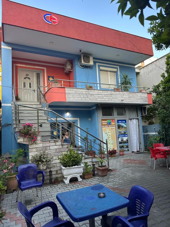 a blue table and chairs in front of a building at Chicago hotel in Fier