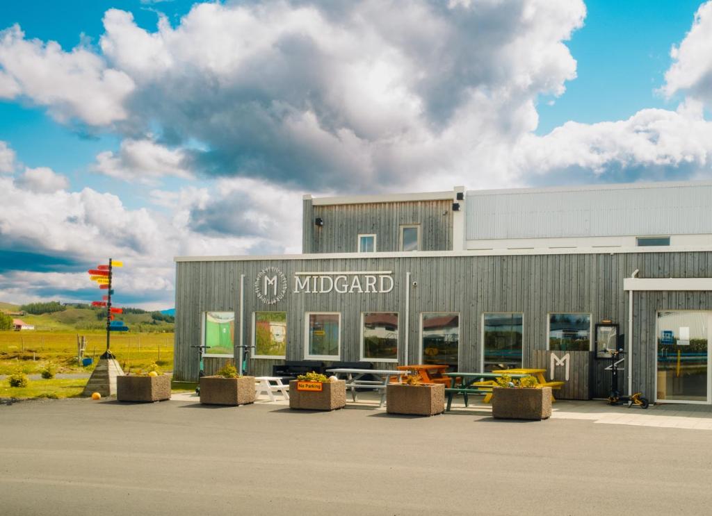 a building with a bunch of tables in front of it at Midgard Base Camp in Hvolsvöllur