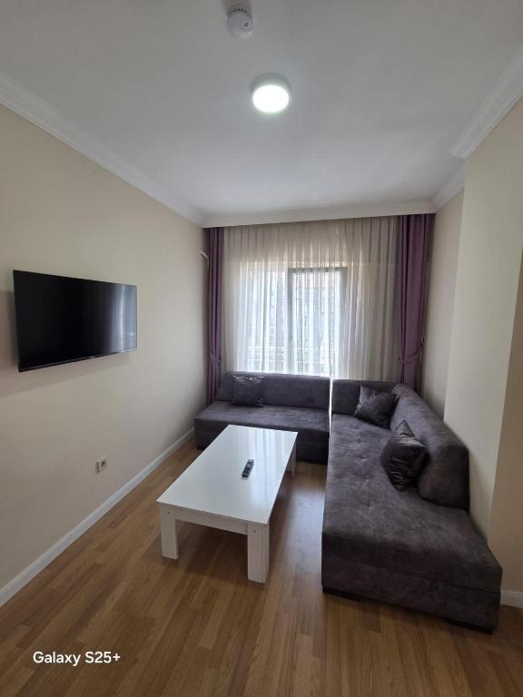 a living room with a couch and a coffee table at Şahinler Suit Apart in Trabzon