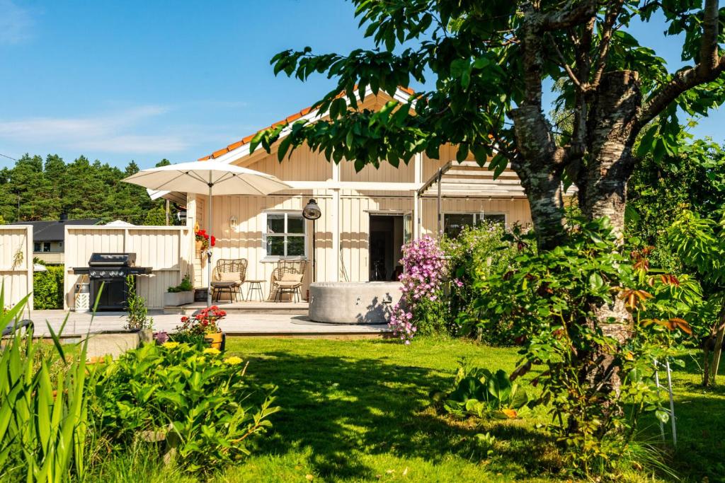 a house with a garden and a tree at Garden House 1 in Hvaler