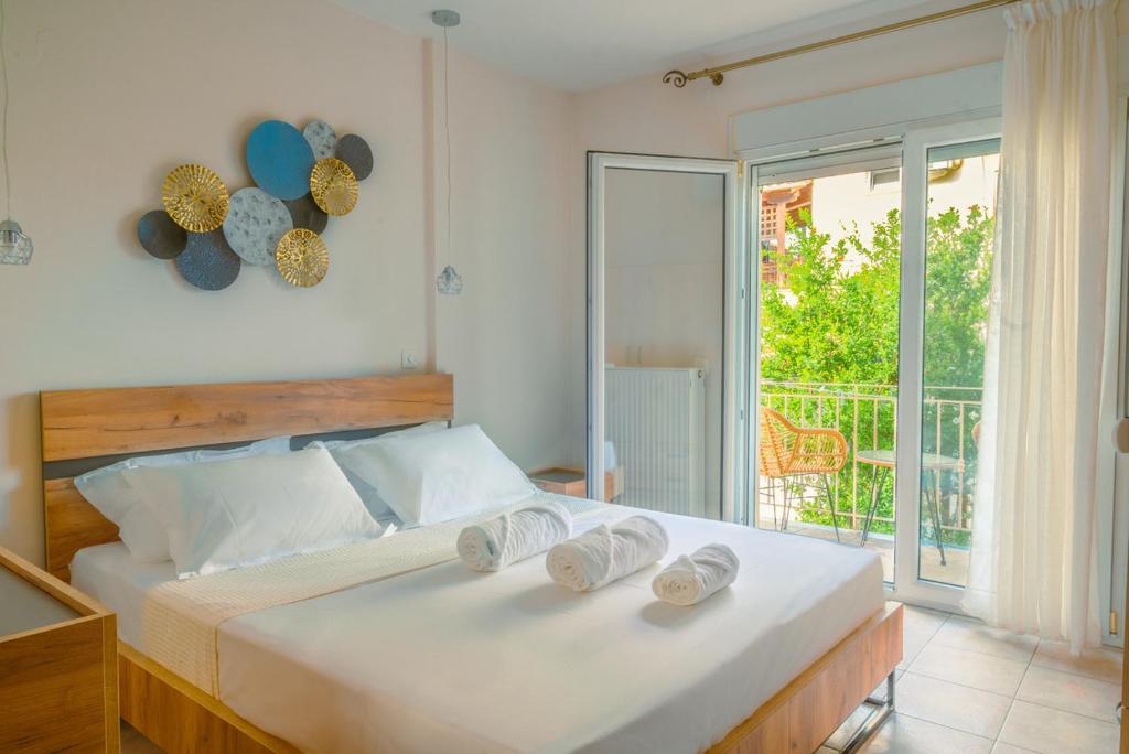 a bedroom with a bed with two towels on it at To Spiti in Keramoti