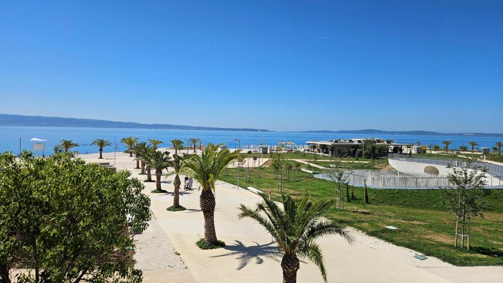 a view of a beach with palm trees and a skate park at Apartments Deja Views - Žnjan beach in Split