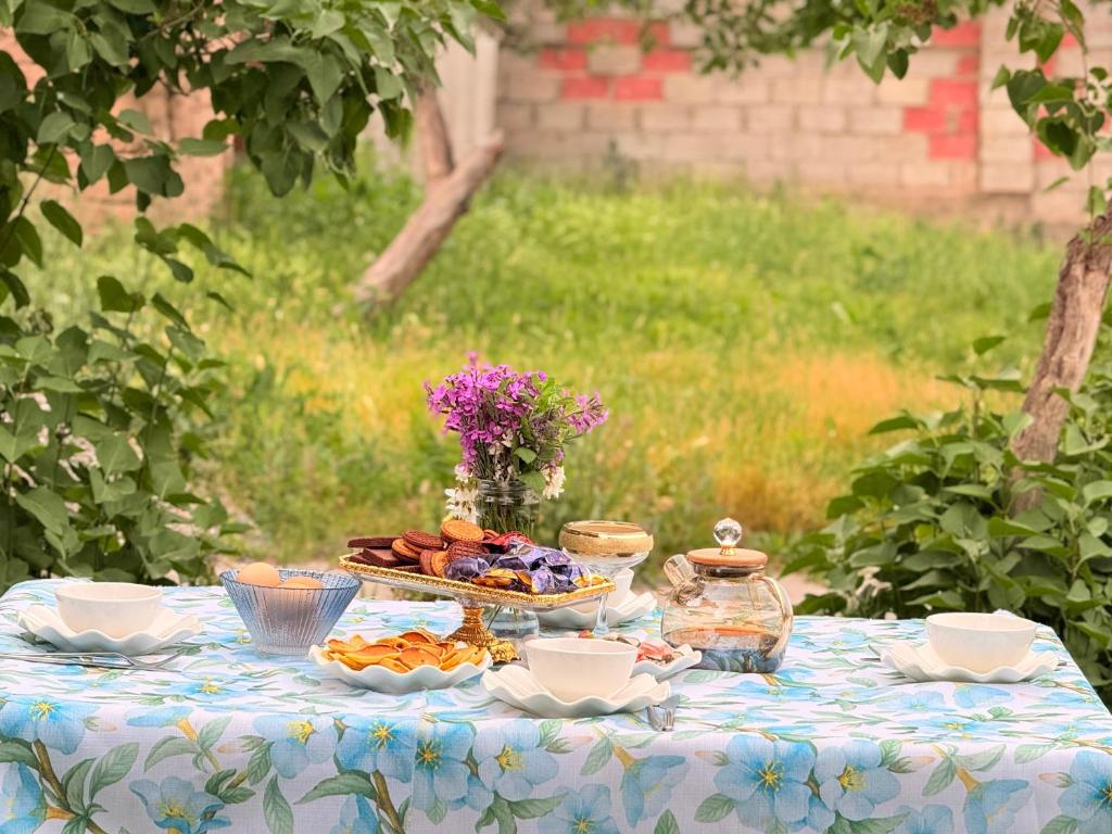 a blue and white table with a plate of food at Уютный дом GS in Kegeti