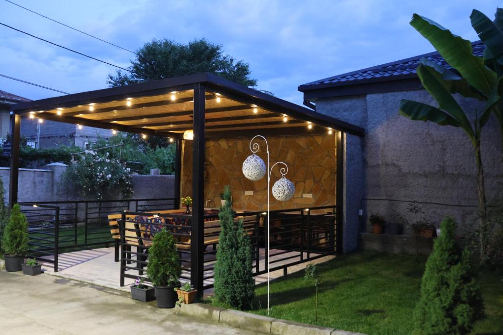 a pergola with lights on it in a yard at Tomas Guesthouse in Lagodekhi