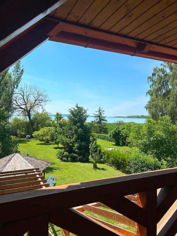 a view from the deck of a house with a view of a yard at La Perla Villa del Lago in Paloznak
