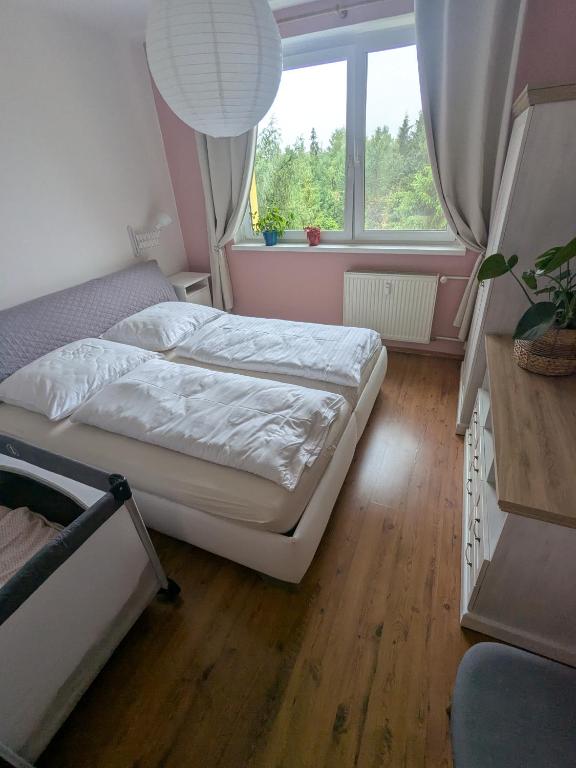 a bedroom with two beds and a window at Summit Suite in Vysoké Tatry