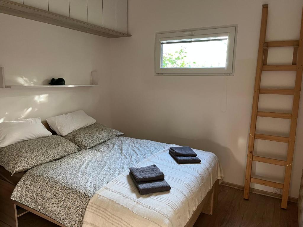 a bedroom with a bed with two towels on it at Tiny House Krumlov, Terrace, Parking in Český Krumlov