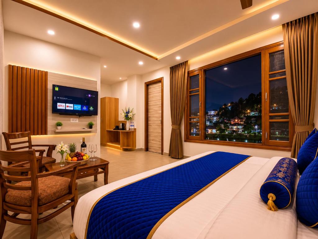 a bedroom with a bed and a table and a window at Hotel Woods inn Dalhousie #MBS Travels # Rooftop # Restaurant # Top Rated Property in Dalhousie