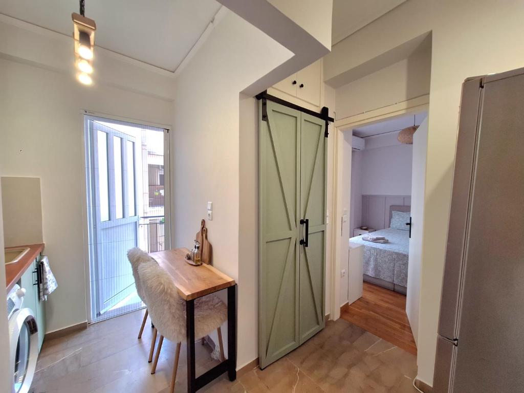 a room with a desk and a door to a bedroom at The Handcrafted Haven 2 min to Central Square in Missolonghi