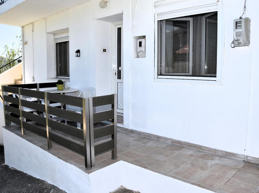 a balcony with a table and a window at Maritsa's Cozy Apartment in Mytilinioí