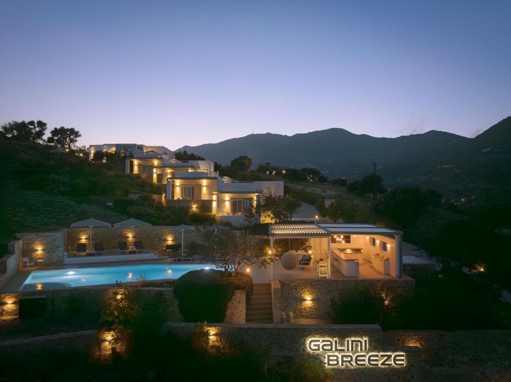 a villa with a swimming pool at night at Galini Breeze in Agia Galini