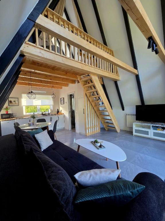 a living room with a couch and a staircase at REIA A-frame in Gura Râului