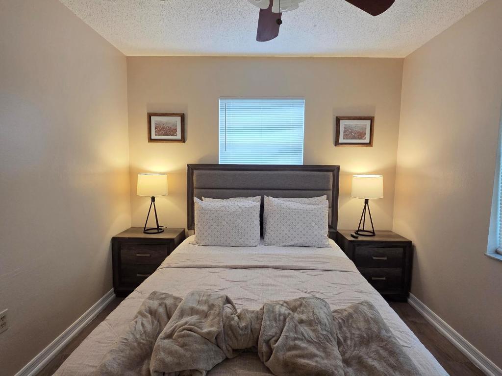 a bedroom with a large bed with two night stands at White Door House! in Winter Haven