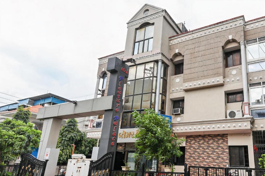 a building on the corner of a street at Hotel Pleasure Palace in Indore