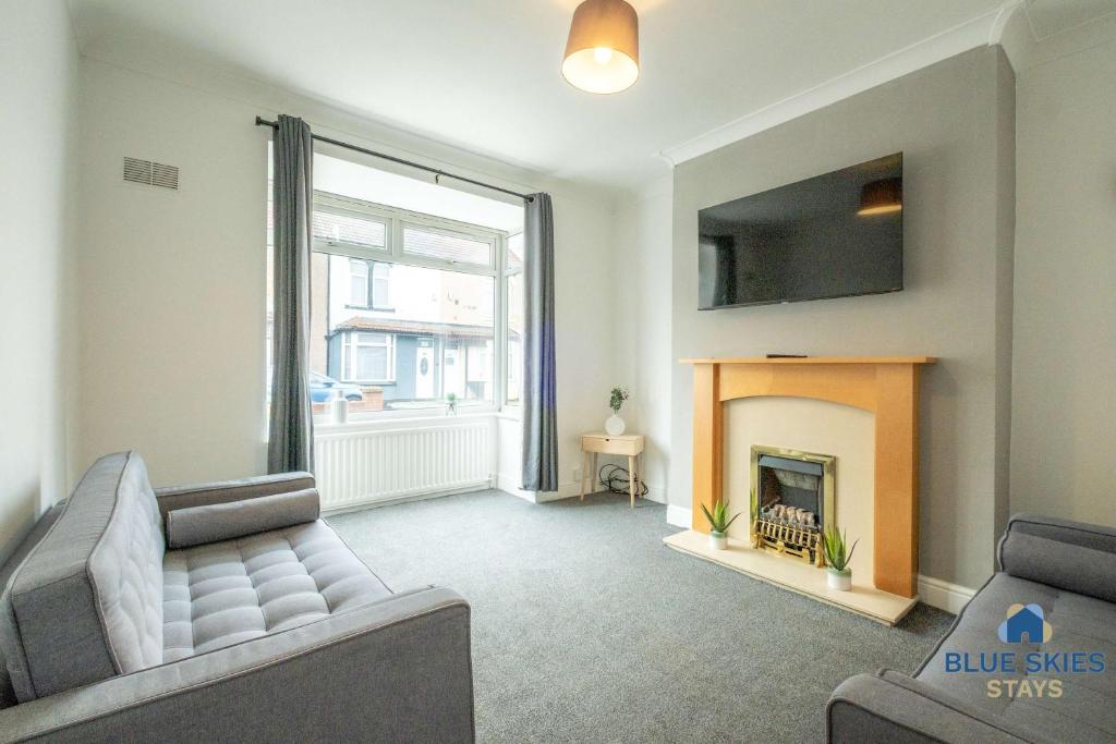 a living room with a couch and a fireplace at Millfield House by Blue Skies Stays in Middlesbrough