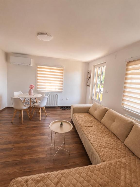 a living room with a couch and a table at Apartman Rosić in Arilje