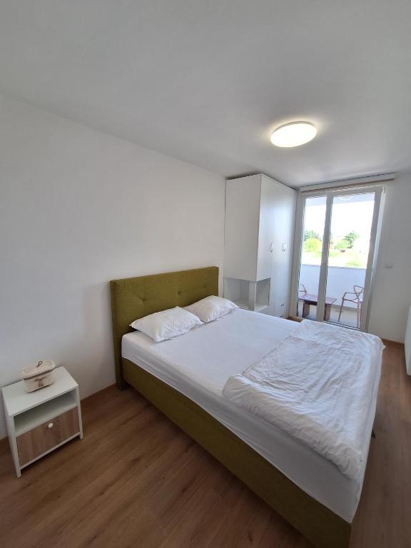 a bedroom with a large bed and a table at Apartment Stup Sarajevo in Sarajevo