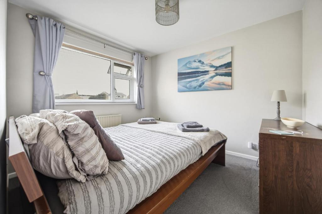 a bedroom with a bed and a window at Saint Johns Rest in Biggleswade