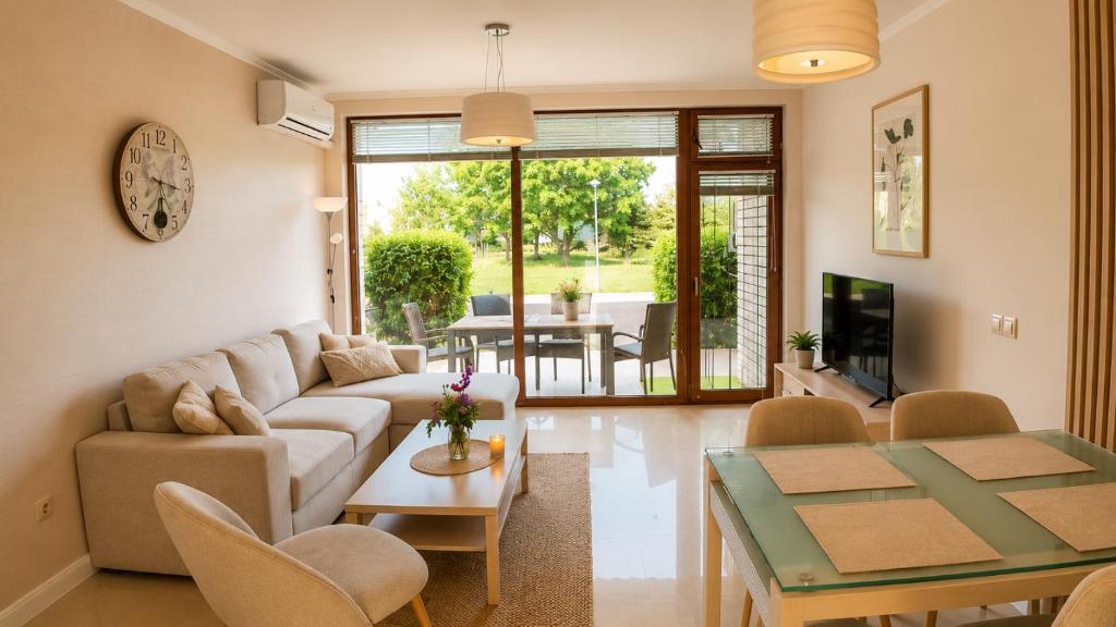 a living room with a couch and a table at Guest House Forest 20 in Balchik