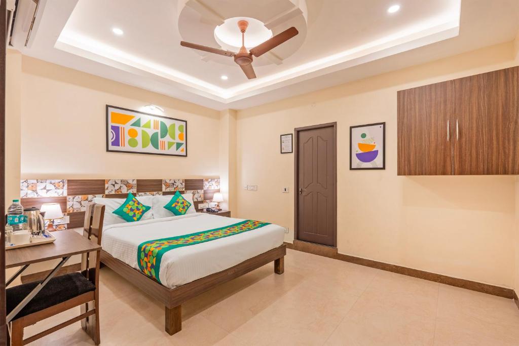 a bedroom with a bed and a ceiling fan at Treebo Golden Sun Inn, 5 Mins To Rock Beach in Pondicherry