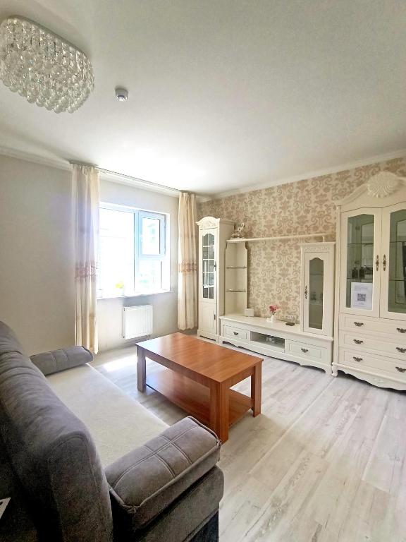a living room with a couch and a table at Darkhan apartment in Darhan