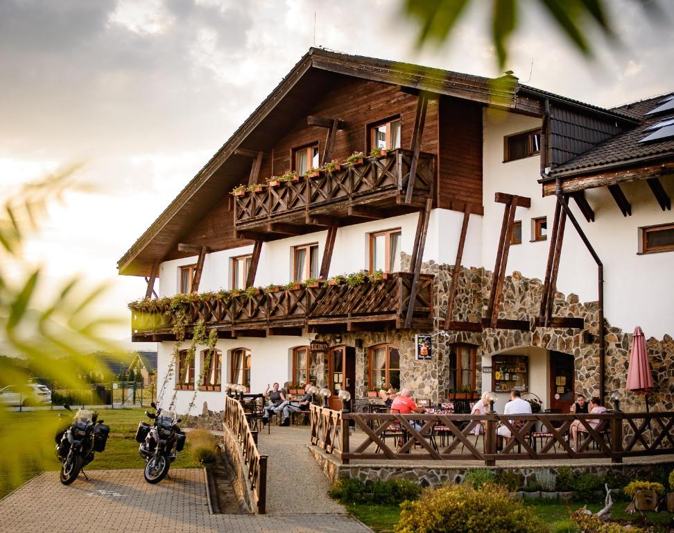 a building with motorcycles parked in front of it at Maravar - Beer Spa - Adults Only in Liptovský Trnovec
