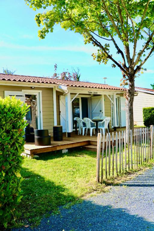 a house with a wooden porch with a fence at NOSTRA LIBERTAT - Piscine - Terrasse in Rivières