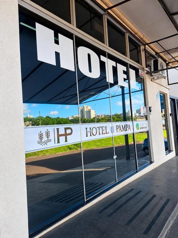 a hotel sign in the window of a building at Hotel Pampa in Nova Santa Medianeira