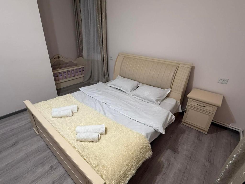 a bedroom with a bed with two towels on it at Dilisharm in Dilijan