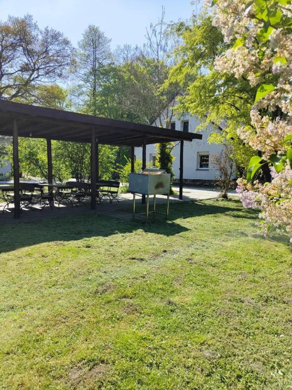 a picnic shelter with a table in a park at Domek- Bożejów in Radomierowice