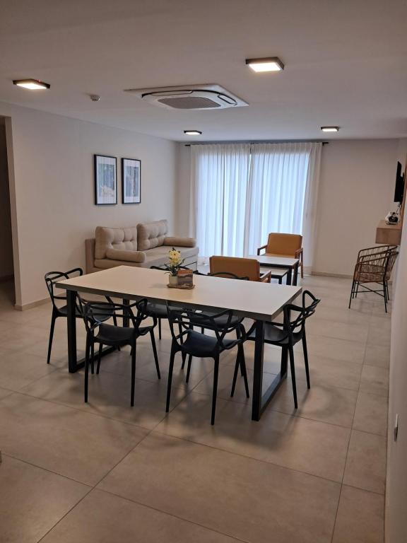 a living room with a table and chairs and a couch at Complejo Coirón Premium in San Rafael