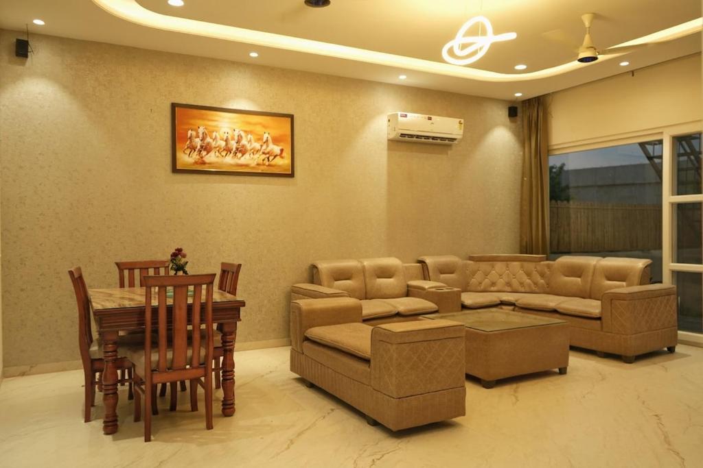 a living room with a couch and a table at Noor Villa Mohali in Lāndrān