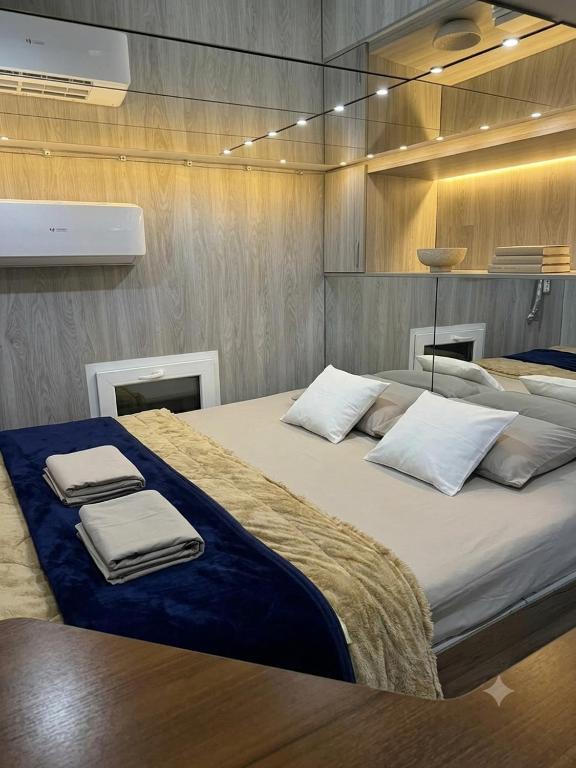 a large bed with towels on it in a room at Central Luxury Studio in Chişinău