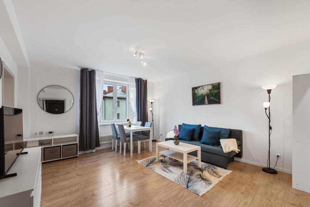 a living room with a couch and a table at City Residence - Sankt Pölten in Sankt Pölten