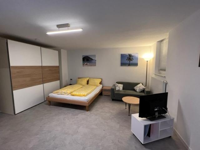 a living room with a bed and a couch at Conny's Ferienwohnung in Bietigheim-Bissingen