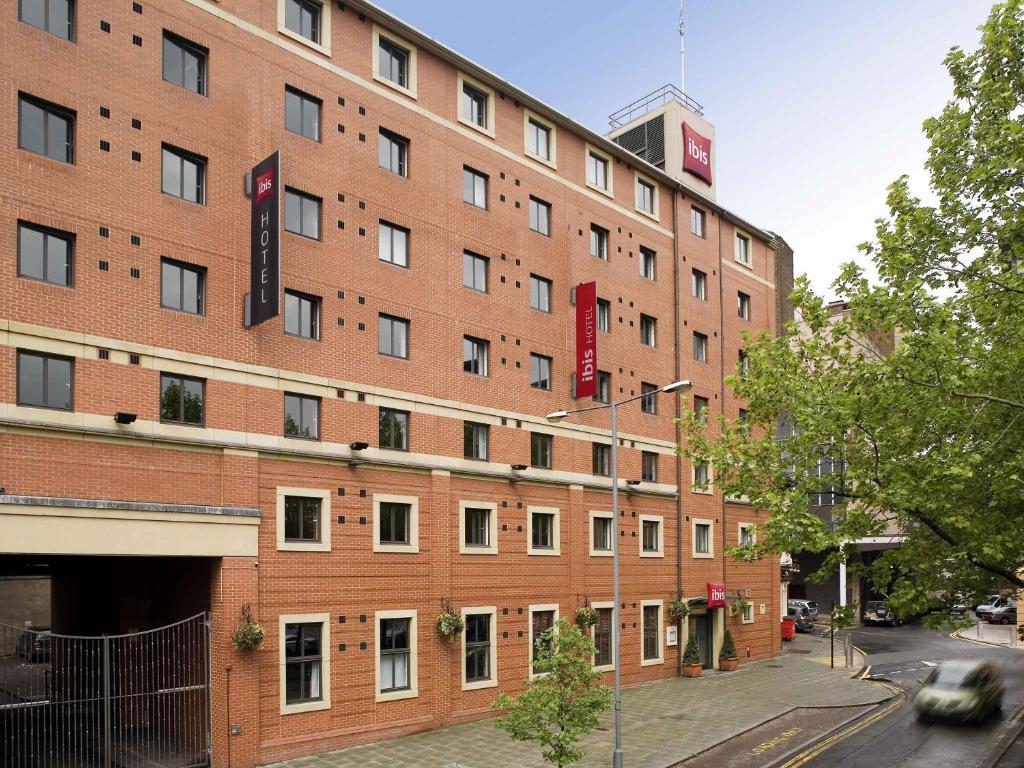 a large brick building on a city street at Ibis Sheffield City in Sheffield