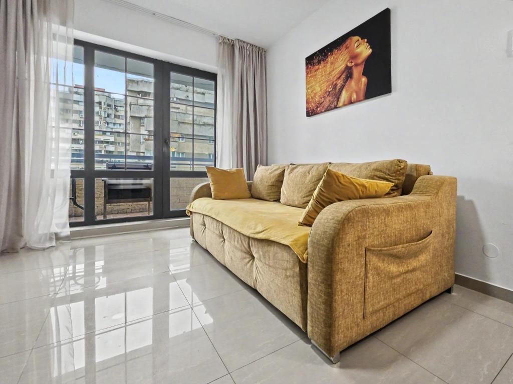 a living room with a couch and a large window at Konstanzer Stefan 15 - Old Town Apt - Palas Mall - AC in Iaşi