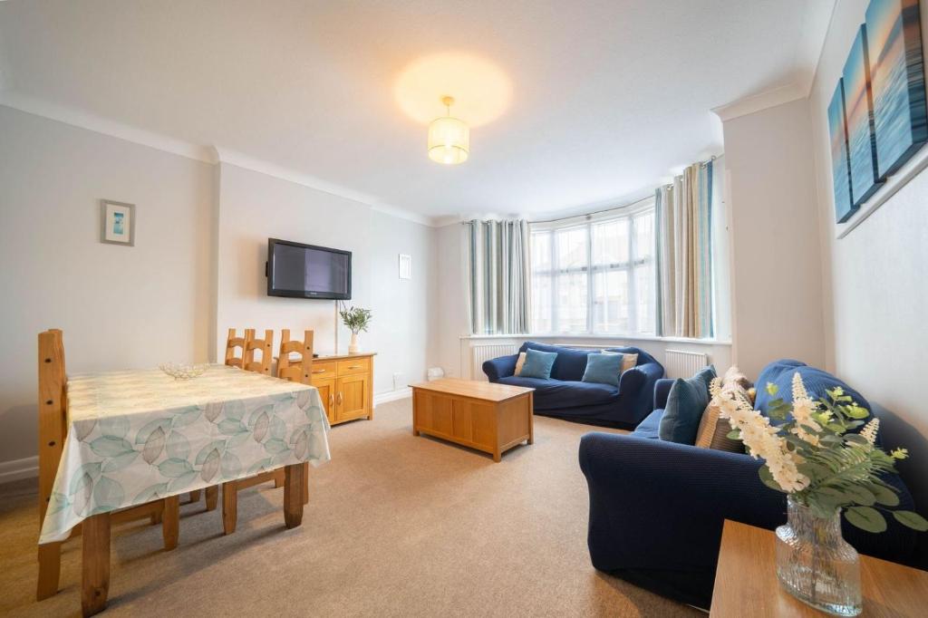a living room with a couch and a table at Lelola Lodge in Bournemouth