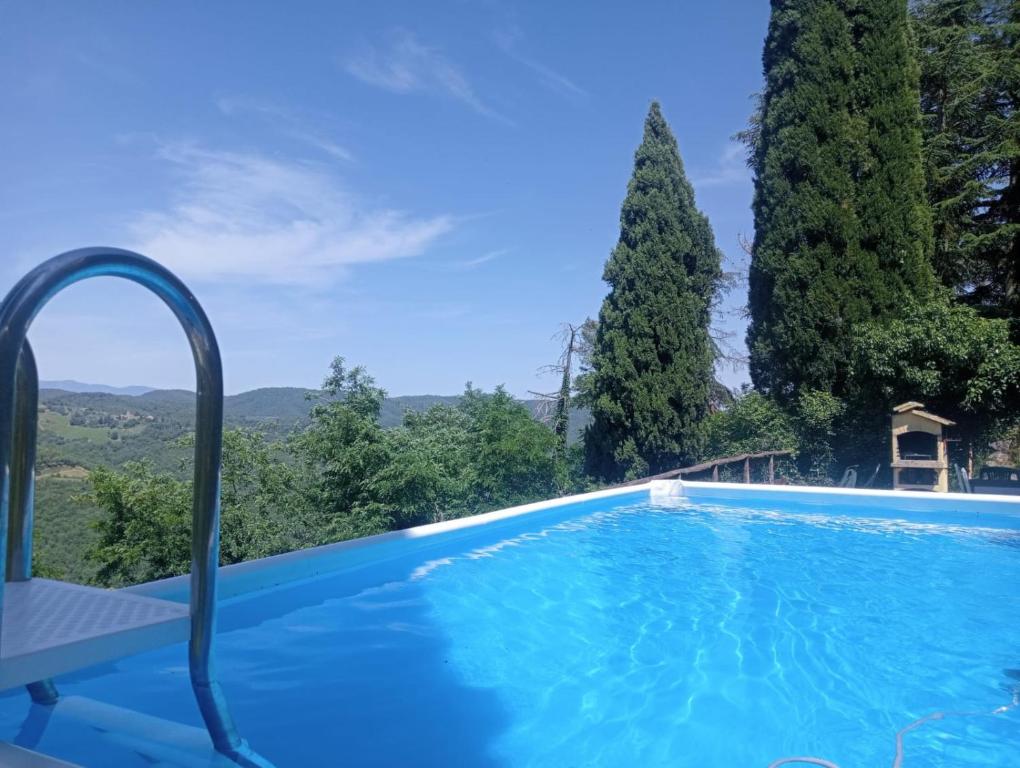 a swimming pool in a villa with trees at Casale Rosennano - Loggia in Rosennano