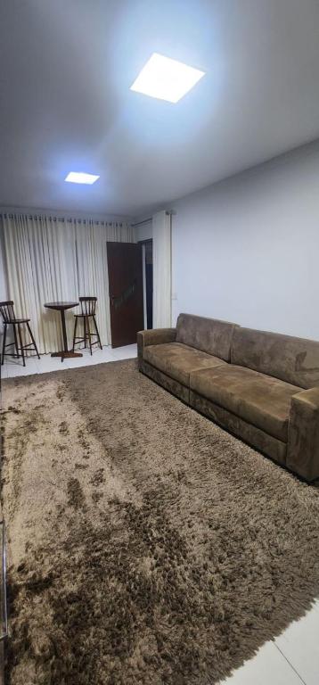 a living room with a couch and a table at Casa confortável para o são joão in Campina Grande