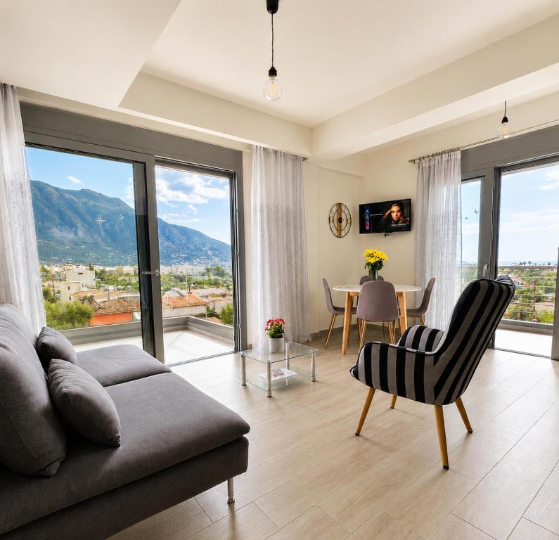 a living room with a couch and a table at Comfy Vista Apartment in Kalamata