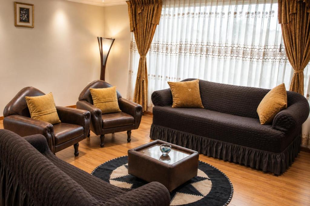 a living room with two couches and two chairs at Comfortable with Private Garage and Excellent Location Rb in Riobamba