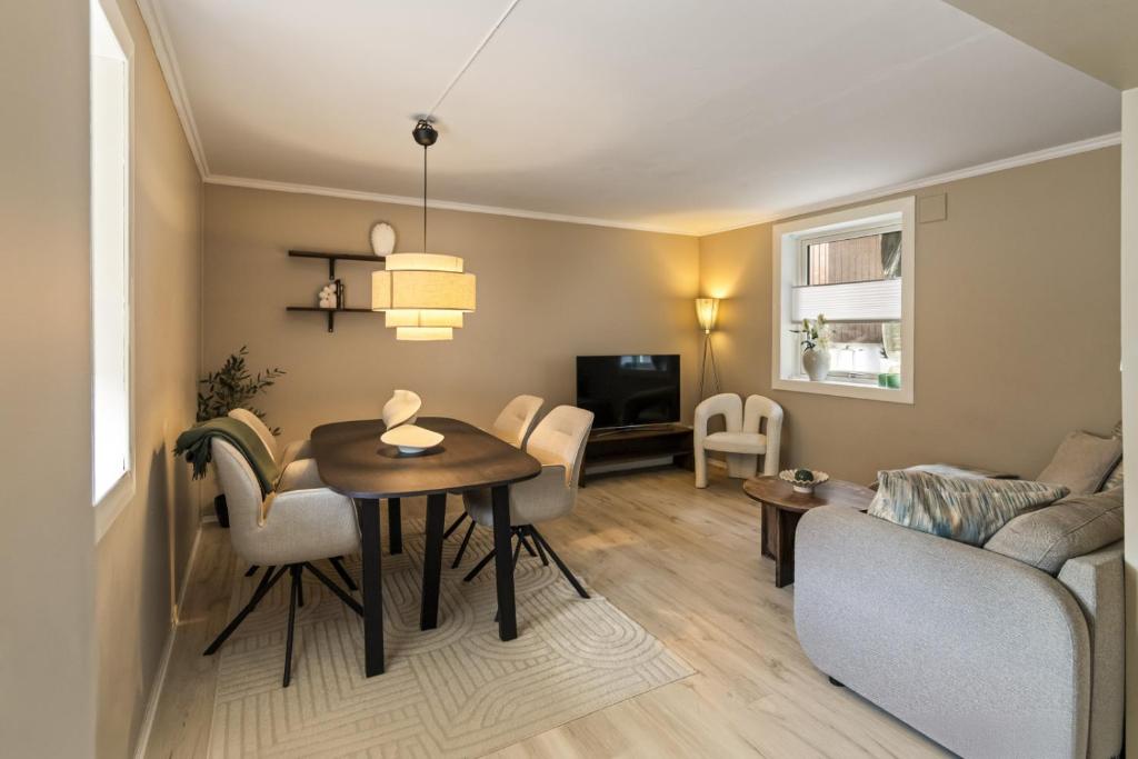 a living room with a table and a couch at Koselig leilighet midt i Tønsberg in Tønsberg