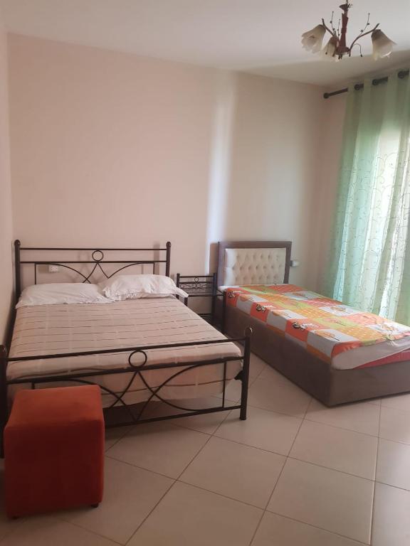 a bedroom with two beds in a room at Familja Kapaj in Polisi i Vogël
