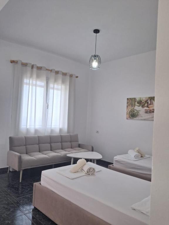 a living room with two beds and a couch at Old Village Apartment in Dhërmi