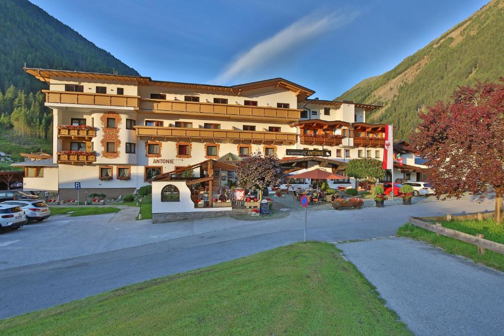 a large building in front of a mountain at Bergsporthotel Antonie in Gries im Sellrain